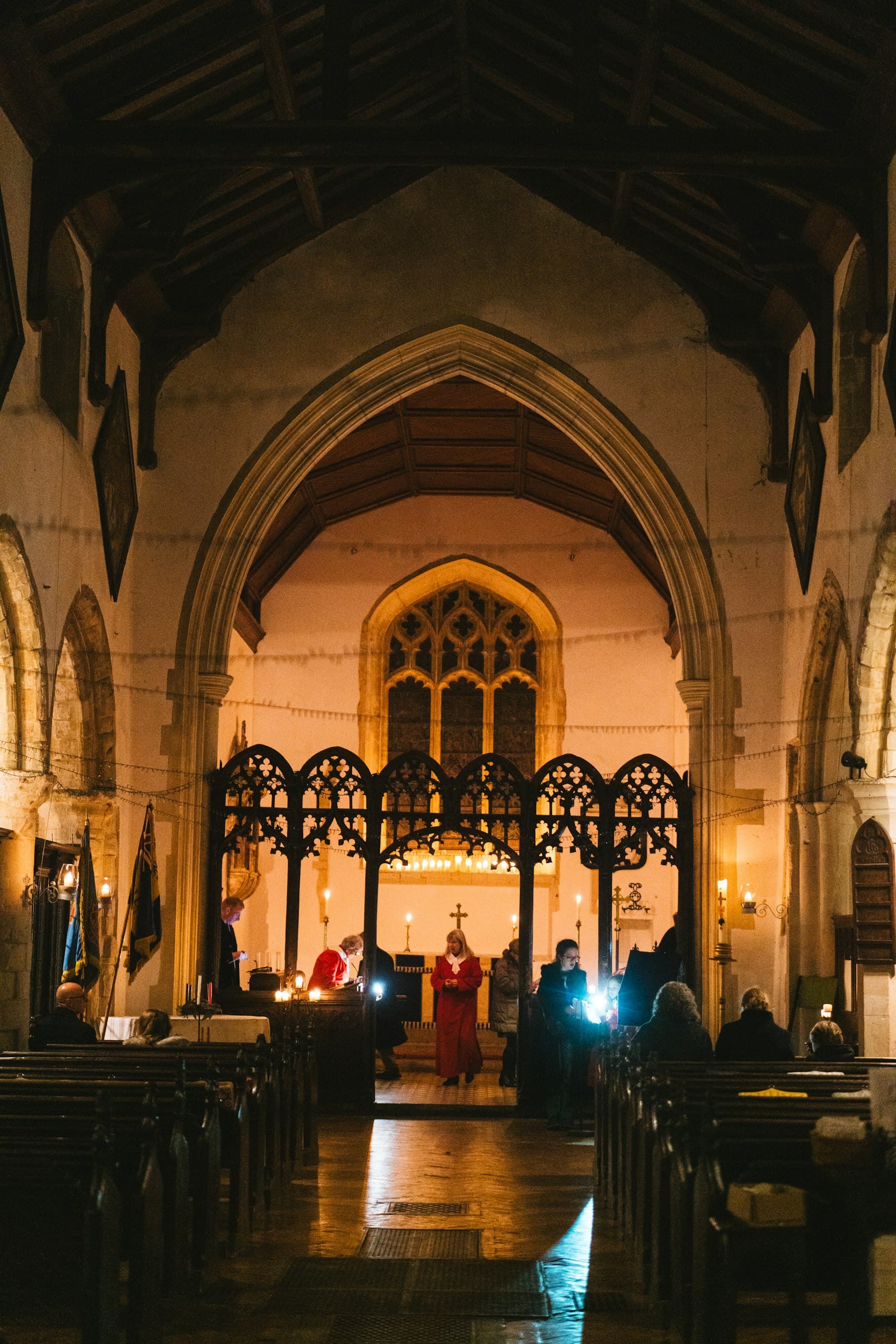 A congregation seated in wooden pews, seen from behind